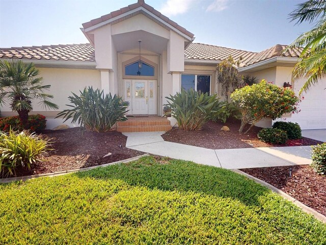 3518 Terin Ct, Punta Gorda, FL 33950 - view of front of property featuring a tile roof, an attached garage, and stucco siding