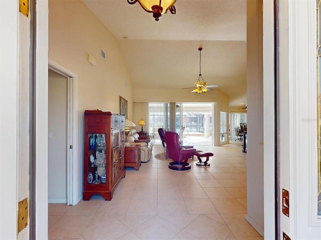 3518 Terin Ct, Punta Gorda, FL 33950 - hallway with light tile patterned floors, high vaulted ceiling, and baseboards