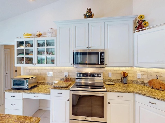 3518 Terin Ct, Punta Gorda, FL 33950 - kitchen with appliances with stainless steel finishes, tasteful backsplash, white cabinets, and light stone countertops