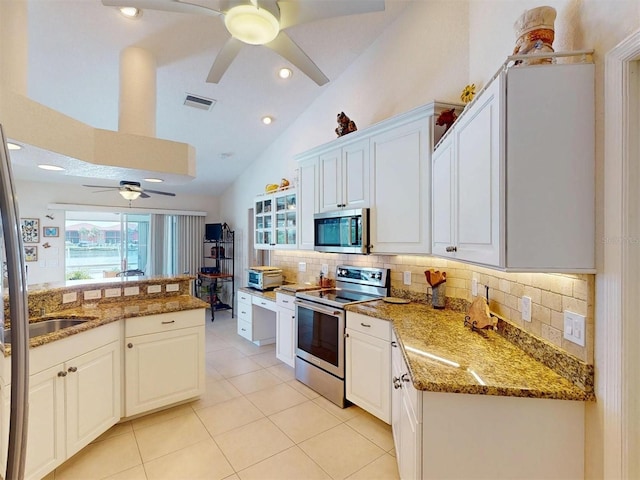 3518 Terin Ct, Punta Gorda, FL 33950 - kitchen with appliances with stainless steel finishes, ceiling fan, tasteful backsplash, light tile patterned flooring, and light stone countertops