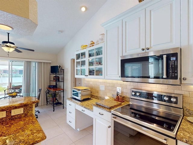 3518 Terin Ct, Punta Gorda, FL 33950 - kitchen featuring appliances with stainless steel finishes, backsplash, ceiling fan, white cabinets, and light tile patterned flooring