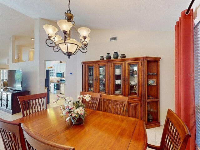 3518 Terin Ct, Punta Gorda, FL 33950 - dining area with a chandelier, light tile patterned floors, and high vaulted ceiling