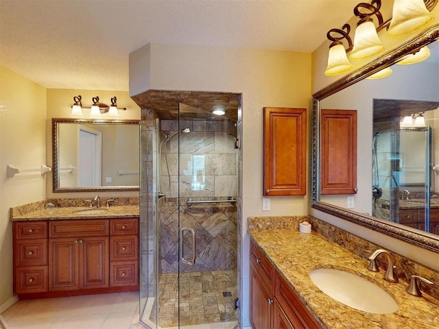 3518 Terin Ct, Punta Gorda, FL 33950 - bathroom with two vanities, a shower stall, tile patterned flooring, and a textured ceiling