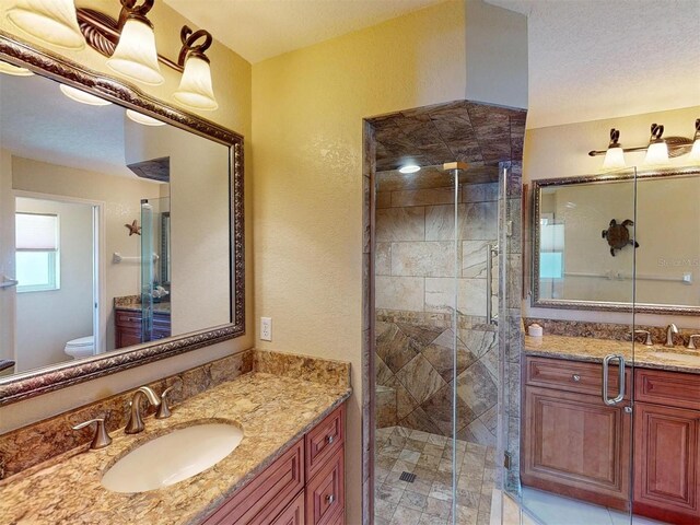 3518 Terin Ct, Punta Gorda, FL 33950 - bathroom featuring toilet, a stall shower, vanity, and a textured wall