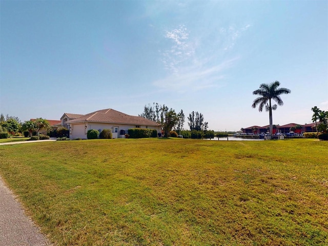 3518 Terin Ct, Punta Gorda, FL 33950 - view of front of house featuring a water view, a garage, a front yard, and driveway