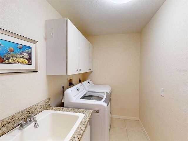 3518 Terin Ct, Punta Gorda, FL 33950 - washroom with independent washer and dryer, cabinet space, light tile patterned floors, baseboards, and a textured ceiling