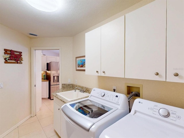 3518 Terin Ct, Punta Gorda, FL 33950 - washroom featuring cabinet space, separate washer and dryer, and light tile patterned floors