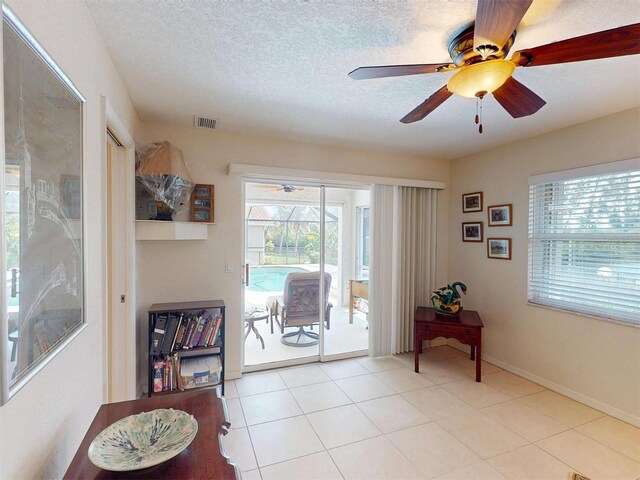 3518 Terin Ct, Punta Gorda, FL 33950 - doorway with ceiling fan, a textured ceiling, and light tile patterned floors