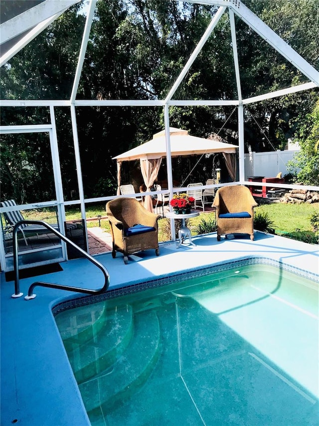 1017 Guild St, Port Charlotte, FL 33952 - view of swimming pool featuring a gazebo, a patio area, a fenced backyard, and a lanai