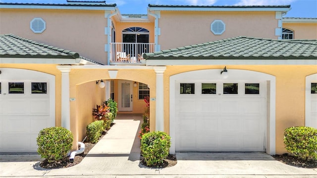 206 Gondola Park Dr Unit 206, Venice, FL 34292 - view of front facade with a balcony, stucco siding, a tiled roof, and concrete driveway