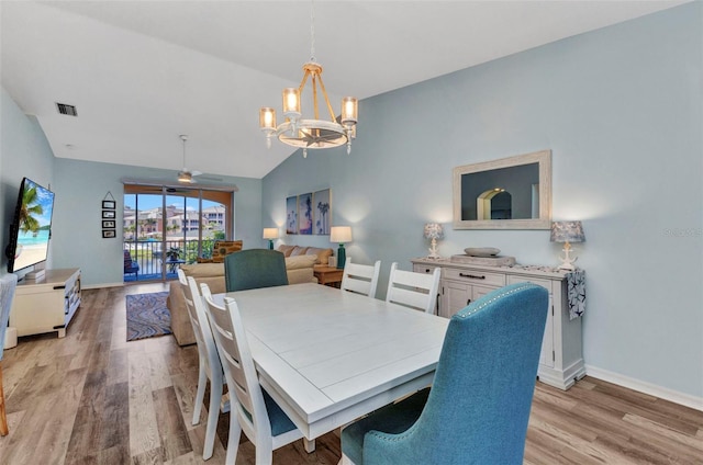 206 Gondola Park Dr Unit 206, Venice, FL 34292 - dining room featuring a chandelier, light wood-type flooring, vaulted ceiling, baseboards, and a ceiling fan