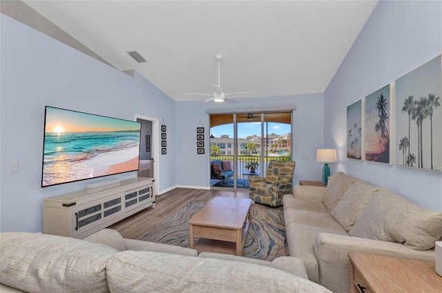 206 Gondola Park Dr Unit 206, Venice, FL 34292 - living area with vaulted ceiling, wood finished floors, a ceiling fan, and baseboards