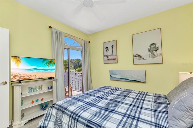 206 Gondola Park Dr Unit 206, Venice, FL 34292 - bedroom with access to exterior, a ceiling fan, and wood finished floors