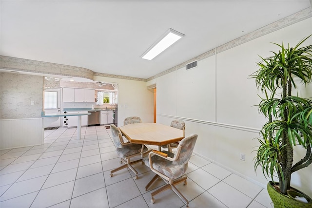 1596 Hayworth Rd, Port Charlotte, FL 33952 - dining area featuring a wainscoted wall and light tile patterned floors