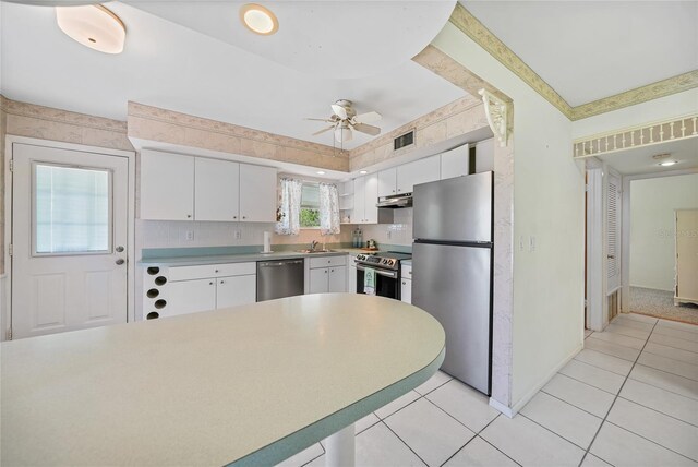1596 Hayworth Rd, Port Charlotte, FL 33952 - kitchen featuring appliances with stainless steel finishes, under cabinet range hood, a ceiling fan, white cabinets, and light countertops