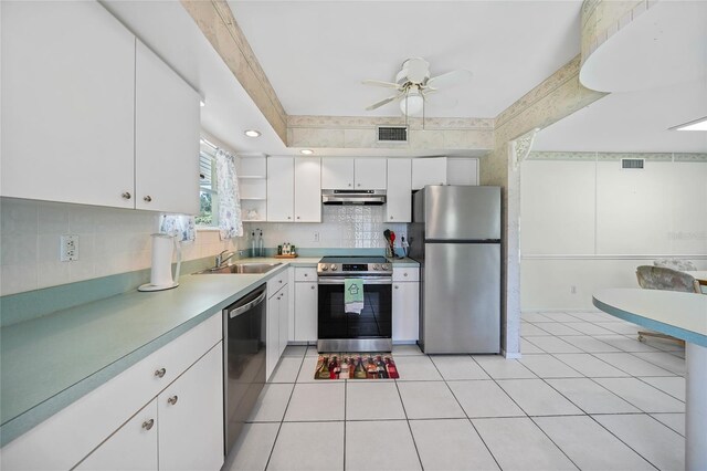 1596 Hayworth Rd, Port Charlotte, FL 33952 - kitchen featuring appliances with stainless steel finishes, a sink, white cabinetry, decorative backsplash, and light countertops