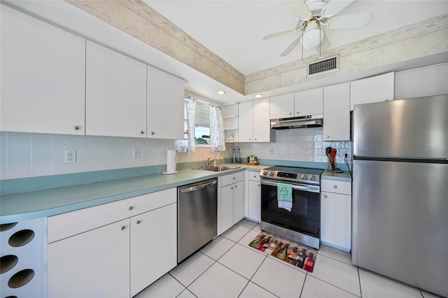 1596 Hayworth Rd, Port Charlotte, FL 33952 - kitchen with appliances with stainless steel finishes, under cabinet range hood, a sink, ceiling fan, and decorative backsplash