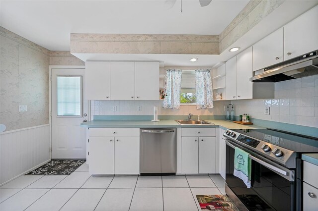 1596 Hayworth Rd, Port Charlotte, FL 33952 - kitchen with appliances with stainless steel finishes, under cabinet range hood, a sink, open shelves, and wallpapered walls