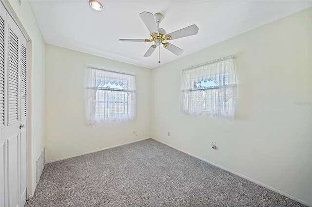 1596 Hayworth Rd, Port Charlotte, FL 33952 - unfurnished bedroom with carpet floors, baseboards, a closet, and ceiling fan