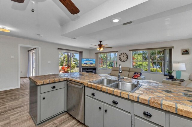 2626 Auburn Blvd, Port Charlotte, FL 33948 - kitchen featuring ceiling fan, a sink, stainless steel dishwasher, open floor plan, and light wood finished floors