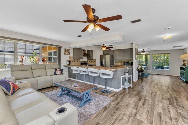 2626 Auburn Blvd, Port Charlotte, FL 33948 - living room with ceiling fan, light wood-style flooring, and baseboards