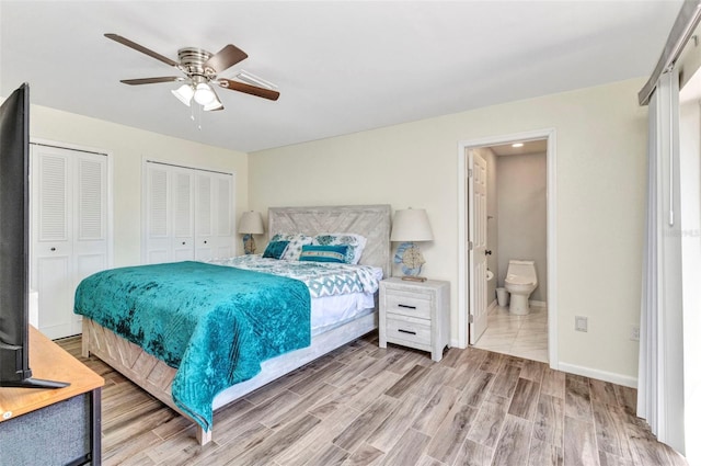 2626 Auburn Blvd, Port Charlotte, FL 33948 - bedroom with two closets, wood finished floors, connected bathroom, a ceiling fan, and baseboards