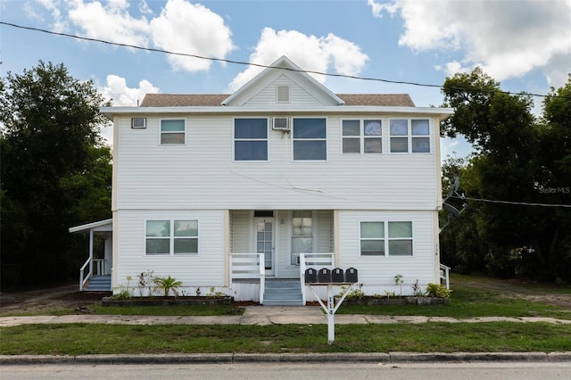114 N Dade Ave, Arcadia, FL 34266 - view of front of home with a porch, roof with shingles, and a front lawn