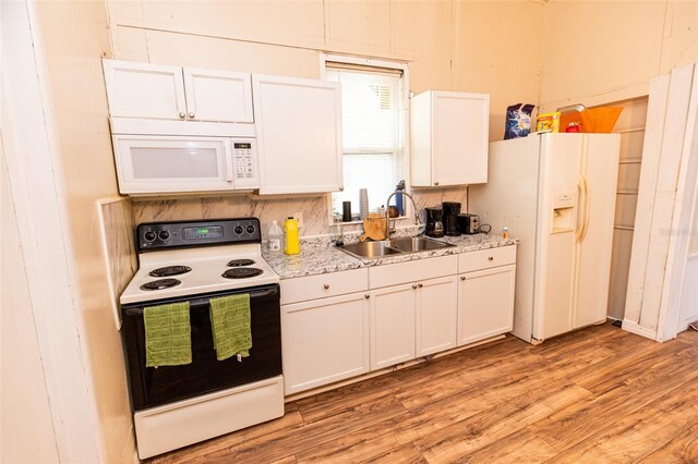 114 N Dade Ave, Arcadia, FL 34266 - kitchen with white appliances, a sink, light wood-type flooring, white cabinets, and light countertops