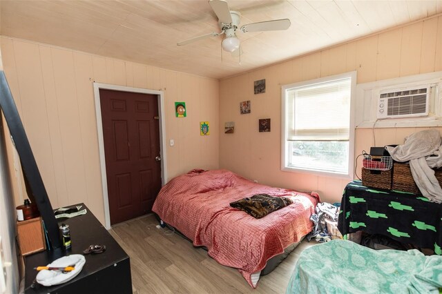 114 N Dade Ave, Arcadia, FL 34266 - bedroom with light wood-type flooring, a wall unit AC, and ceiling fan