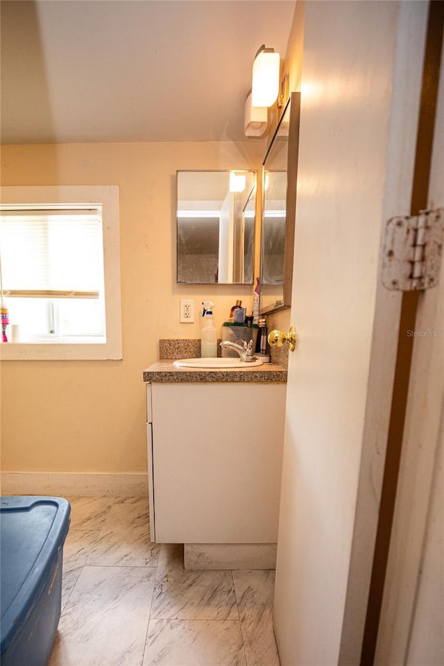 114 N Dade Ave, Arcadia, FL 34266 - bathroom with vanity, baseboards, and marble finish flooring