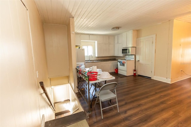 114 N Dade Ave, Arcadia, FL 34266 - kitchen with electric stove, stainless steel microwave, a sink, wooden ceiling, and dark wood-style floors