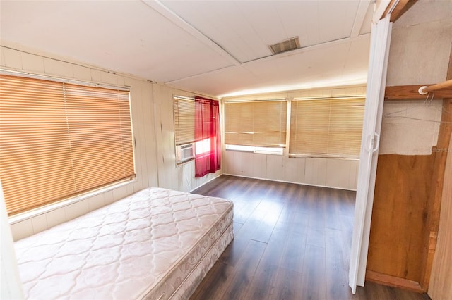 114 N Dade Ave, Arcadia, FL 34266 - bedroom featuring dark wood finished floors, wood walls, and cooling unit