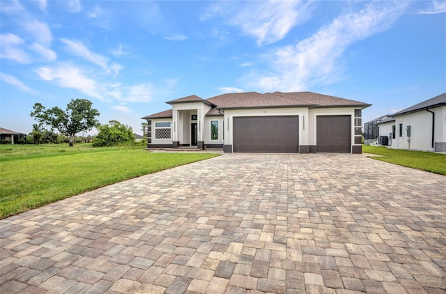 15 Tournament Rd, Rotonda West, FL 33947 - prairie-style house featuring decorative driveway, a garage, a front lawn, and stucco siding