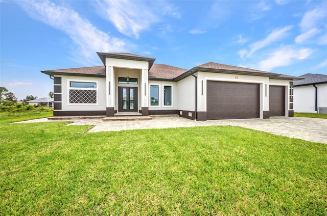15 Tournament Rd, Rotonda West, FL 33947 - prairie-style house featuring french doors, a garage, decorative driveway, a front lawn, and stucco siding