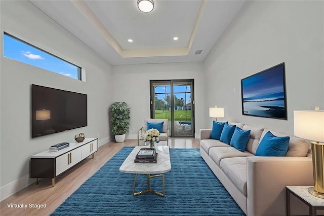 15 Tournament Rd, Rotonda West, FL 33947 - living area featuring light wood finished floors, a raised ceiling, and recessed lighting