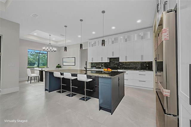 15 Tournament Rd, Rotonda West, FL 33947 - kitchen with tasteful backsplash, white cabinetry, a breakfast bar area, a spacious island, and recessed lighting