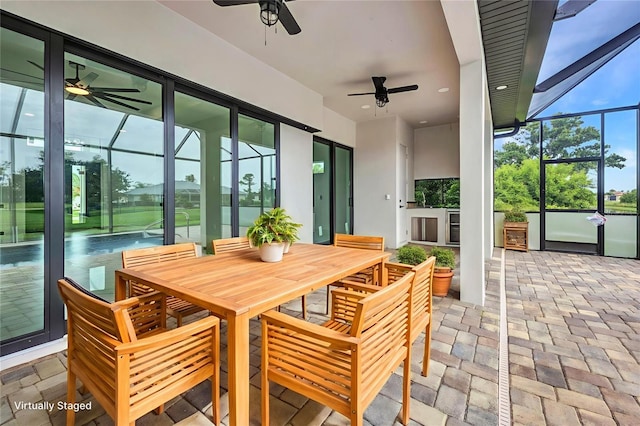 15 Tournament Rd, Rotonda West, FL 33947 - sunroom with ceiling fan, exterior kitchen, and healthy amount of natural light