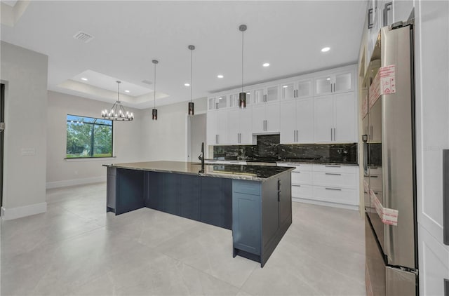 15 Tournament Rd, Rotonda West, FL 33947 - kitchen featuring tasteful backsplash, white cabinetry, a chandelier, dark stone counters, and recessed lighting