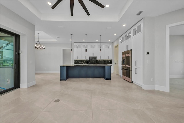 15 Tournament Rd, Rotonda West, FL 33947 - kitchen with a raised ceiling, high end refrigerator, white cabinetry, dark countertops, and a ceiling fan