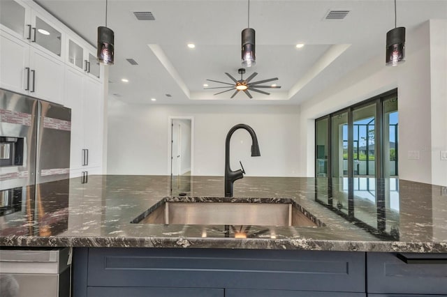 15 Tournament Rd, Rotonda West, FL 33947 - kitchen with dark stone counters, white cabinetry, stainless steel fridge with ice dispenser, pendant lighting, and recessed lighting