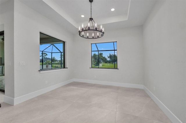 15 Tournament Rd, Rotonda West, FL 33947 - unfurnished room featuring a chandelier, recessed lighting, a raised ceiling, and light tile patterned floors
