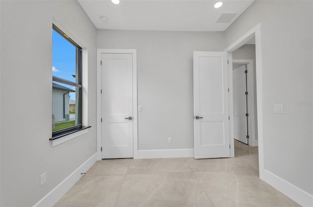 15 Tournament Rd, Rotonda West, FL 33947 - unfurnished bedroom with light tile patterned floors and recessed lighting