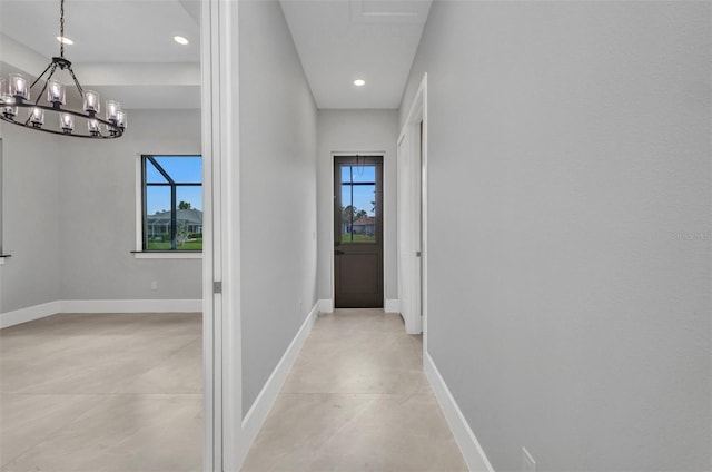 15 Tournament Rd, Rotonda West, FL 33947 - hallway featuring healthy amount of natural light, a chandelier, recessed lighting, and concrete flooring