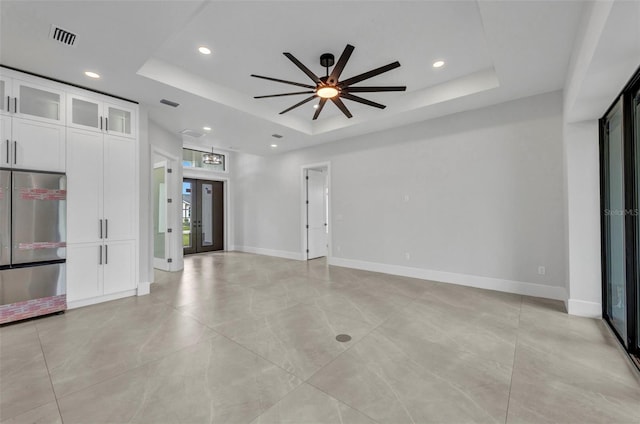 15 Tournament Rd, Rotonda West, FL 33947 - unfurnished living room with a raised ceiling, a ceiling fan, recessed lighting, and light tile patterned flooring