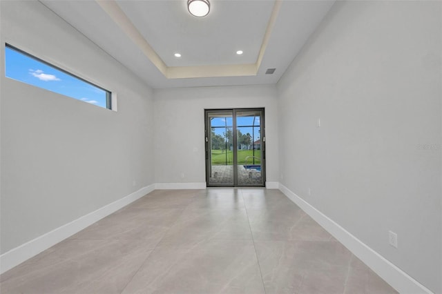 15 Tournament Rd, Rotonda West, FL 33947 - unfurnished room featuring recessed lighting, a tray ceiling, and concrete floors