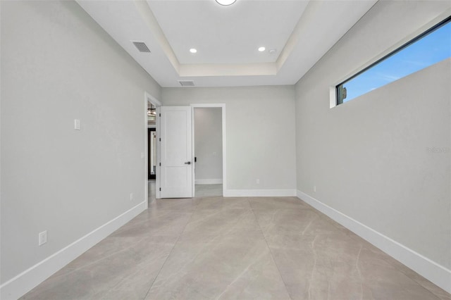 15 Tournament Rd, Rotonda West, FL 33947 - empty room with concrete floors, a tray ceiling, and recessed lighting