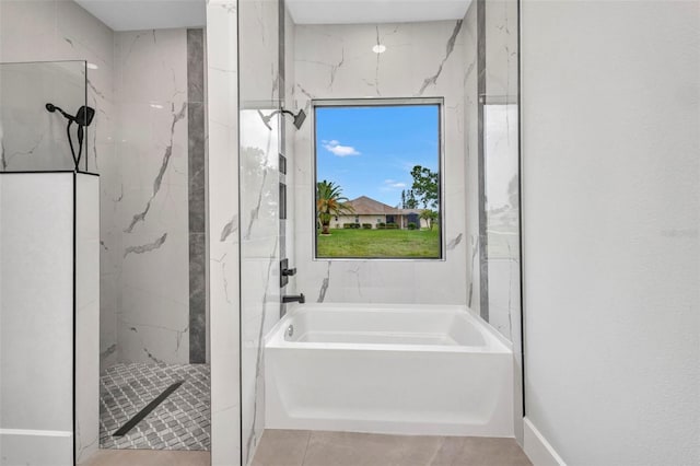 15 Tournament Rd, Rotonda West, FL 33947 - bathroom with a bath, a marble finish shower, and tile patterned floors