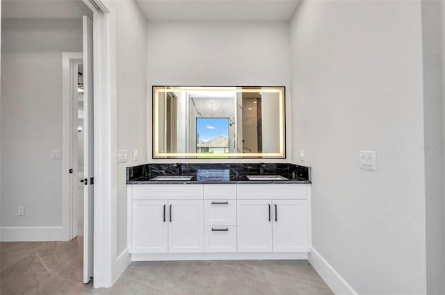 15 Tournament Rd, Rotonda West, FL 33947 - full bathroom with double vanity and baseboards