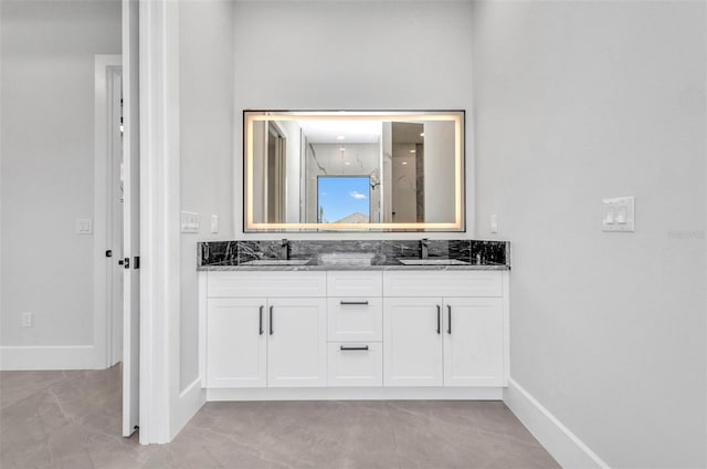 15 Tournament Rd, Rotonda West, FL 33947 - bathroom with double vanity, a marble finish shower, and tile patterned floors