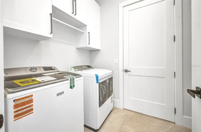 15 Tournament Rd, Rotonda West, FL 33947 - laundry room featuring washer and clothes dryer, cabinet space, and light tile patterned floors
